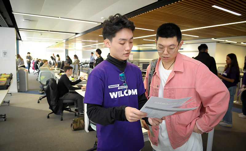 A student staff member helps a new student at an Immigration Right to Study Check event