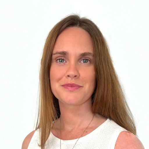 Image of a woman on a blurred white background in a white shirt. 