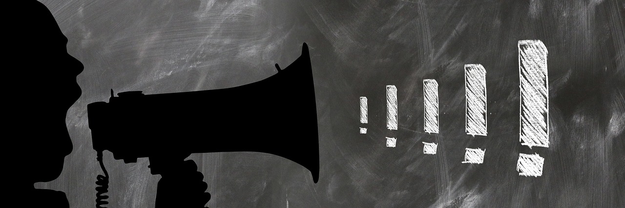 The silhouette of a figure shouting into a megaphone, followed by exclamation marks.
