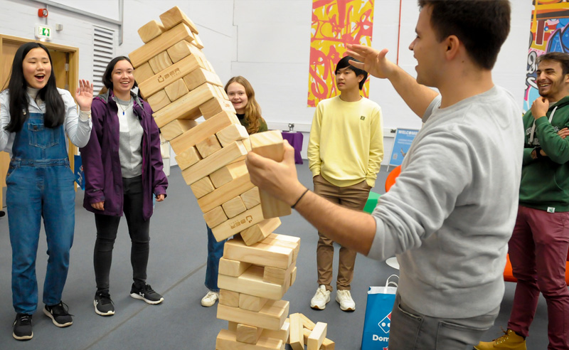 A group of students playing giant Jenga