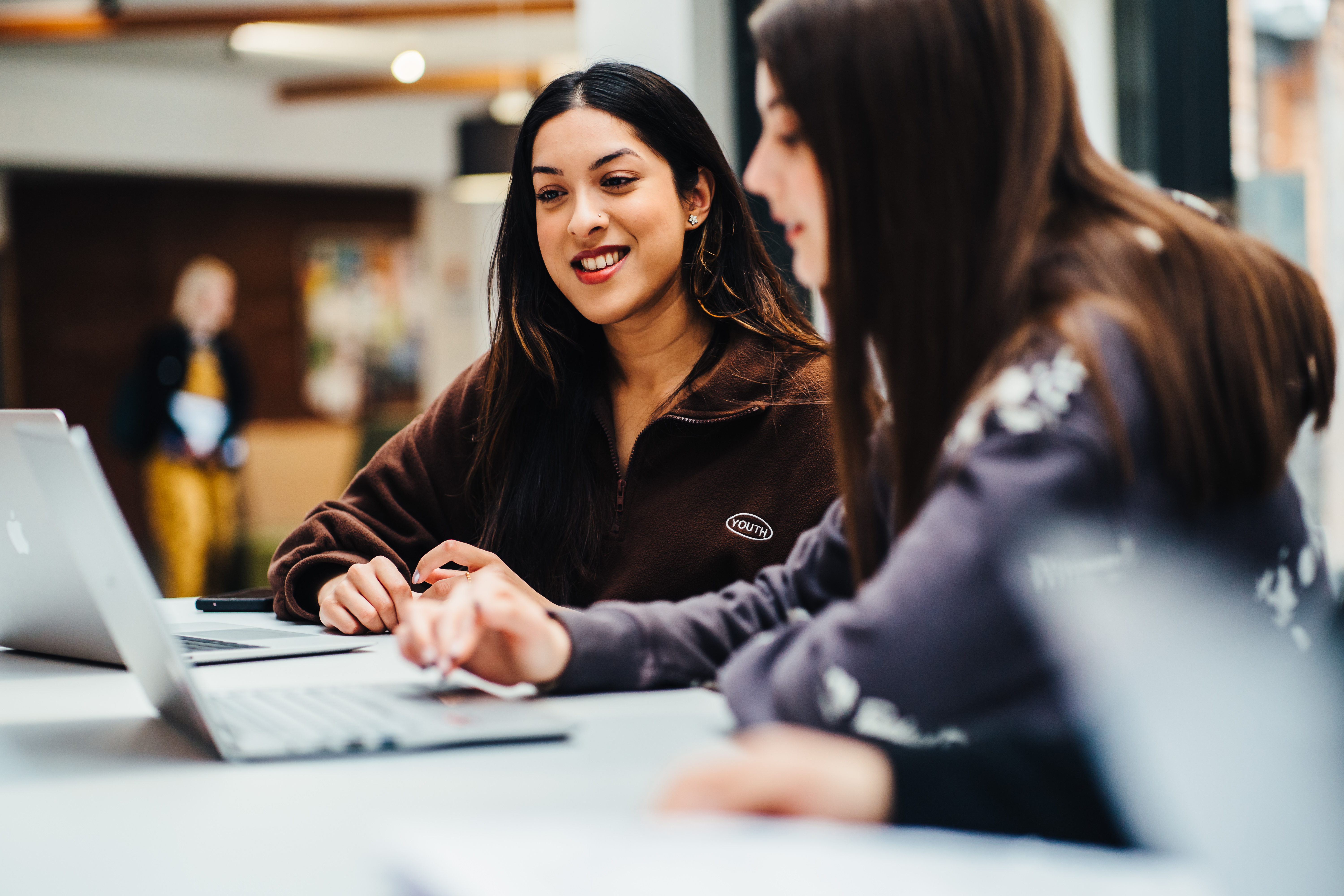 Two people smiling and chatting
