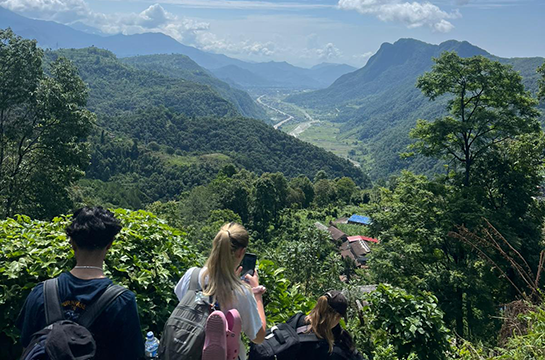 A group of people descending a mountain path
