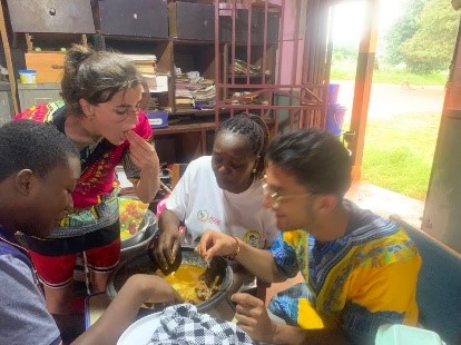 Student sharing local cuisine with African school teahers