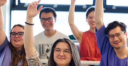 A group of students with raised hands
