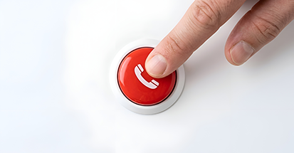 A finger pressing a red call button