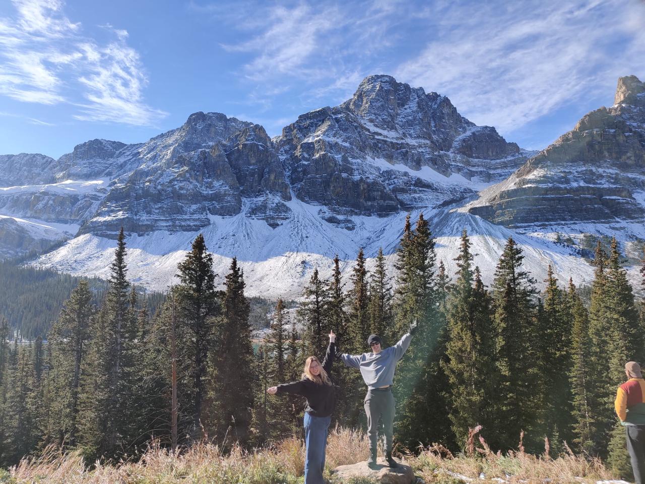 mountain scene 2 students with arms outstretched