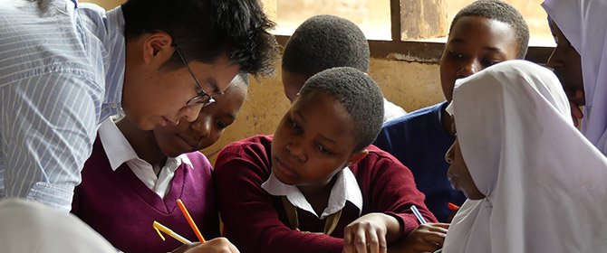 A Warwick student in a classroom in South Africa with pupils