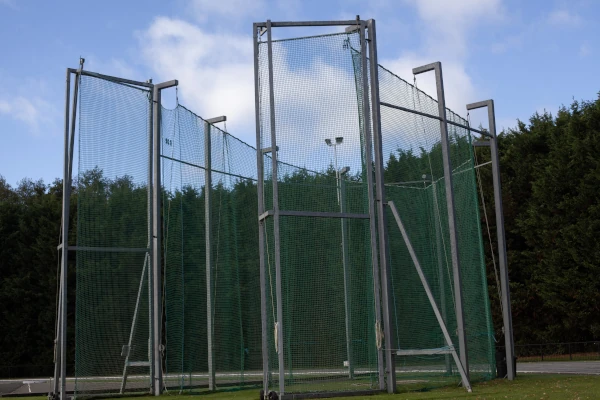 Hammer throw cages at an athletics track