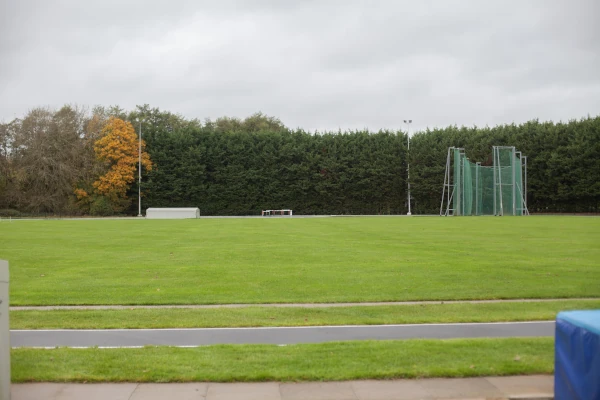 Grass field for javelin throwing in the middle of athletcis track
