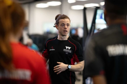 A photo of an instructor leading a strength and conditioning class