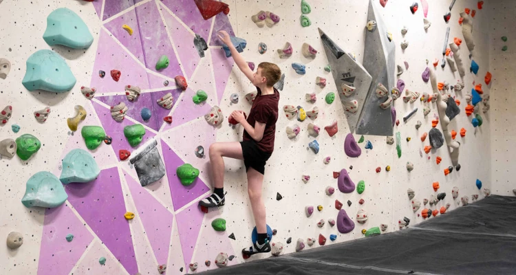 photo of a person starting a bouldering climb