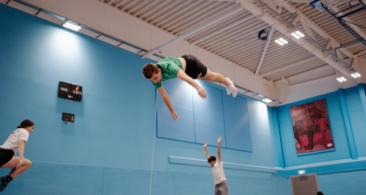 Dan Smith performing on a trampoline