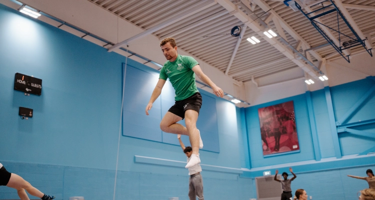 Dan Smith performing on a trampoline