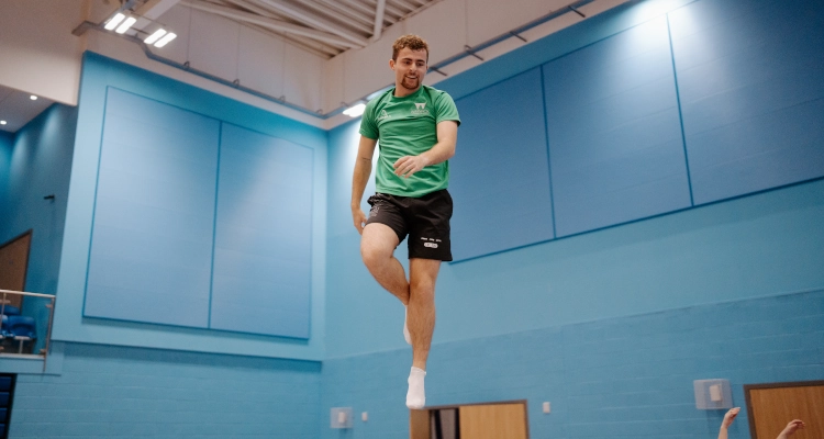 Dan Smith performing on a trampoline