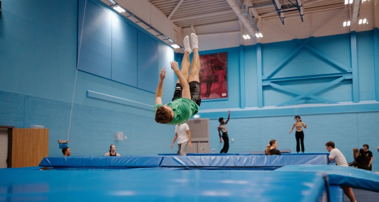 Dan Smith performing on a trampoline