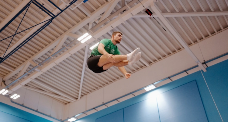 Dan Smith performing on a trampoline