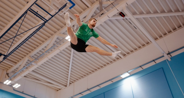Dan Smith performing on a trampoline