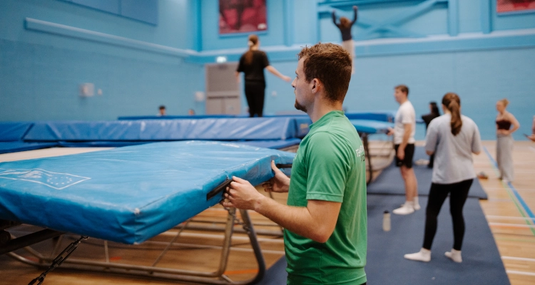 Dan Smith performing on a trampoline