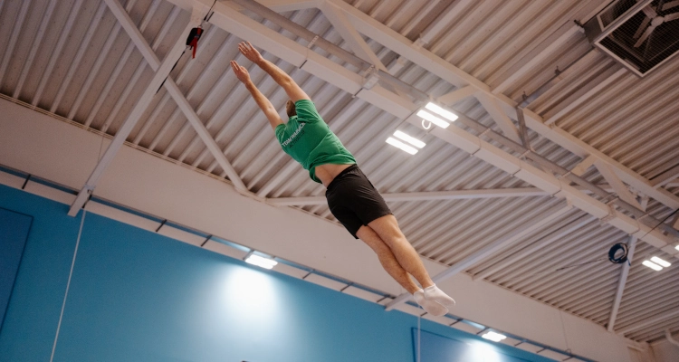Dan Smith performing on a trampoline