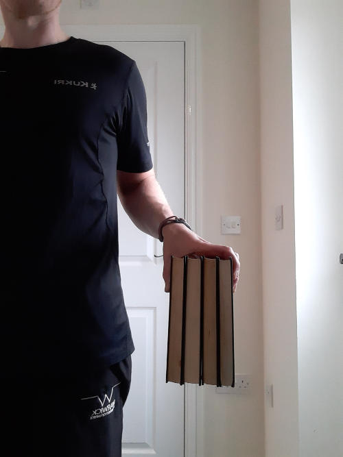 Hand lifting up 4 books