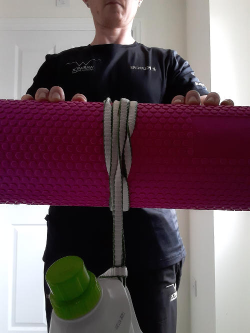 Hands holding wide roller with rope wound up