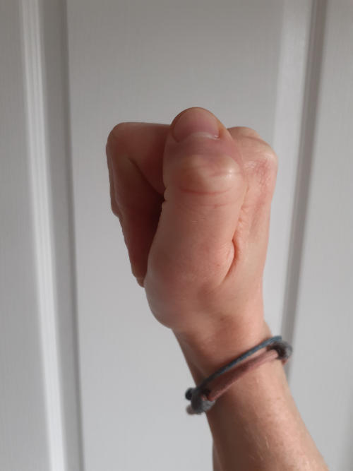 Hand making a flat fist