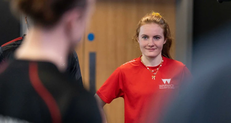 person in red warwick sport top