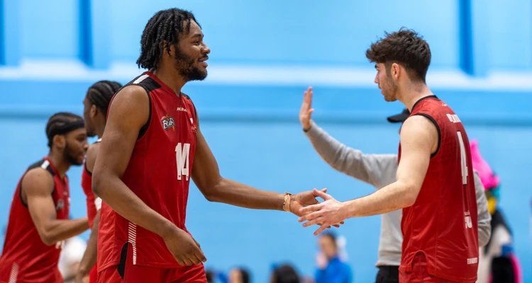two basketball players shaking hands at a game