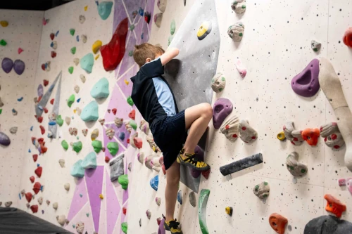 A child ascends the climbing wall