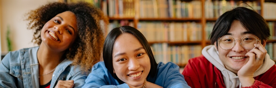 Three students smiling at the camera