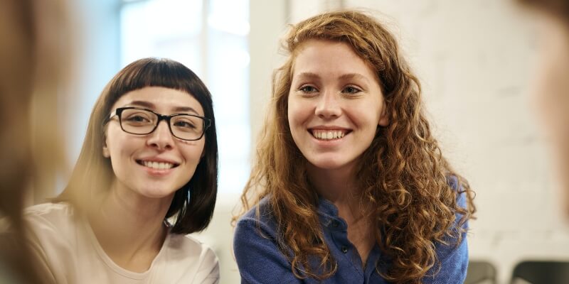 Two students smiling