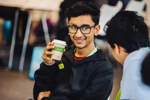 Two men and one is drinking a tea