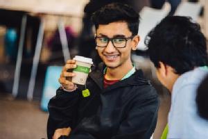 Two men and one is drinking a tea