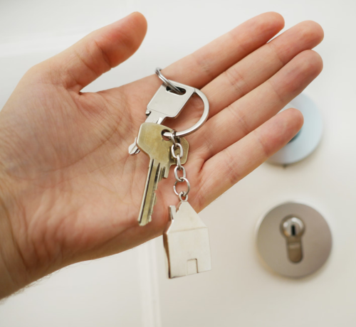 A person holding keys to a house