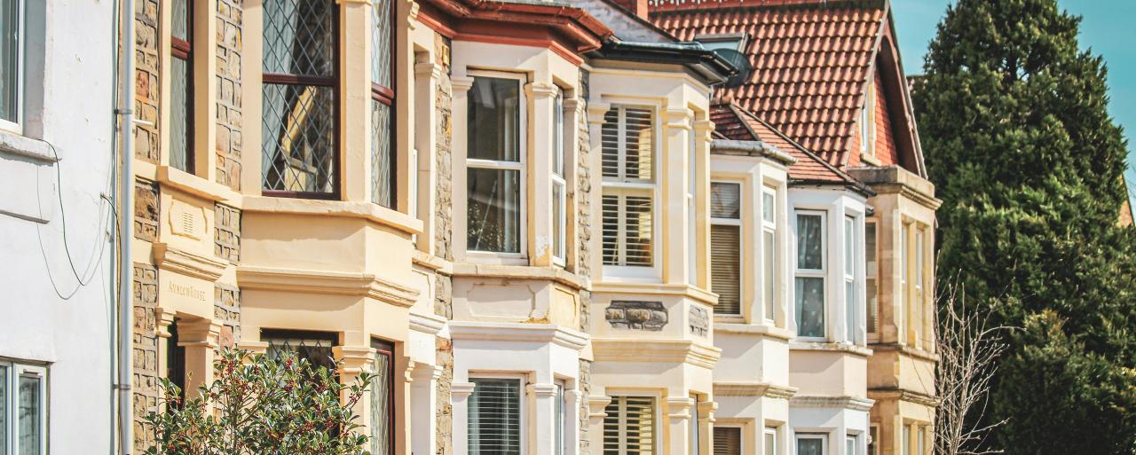 Image of terraced houses taken at an angle to show the many bay windows in a row