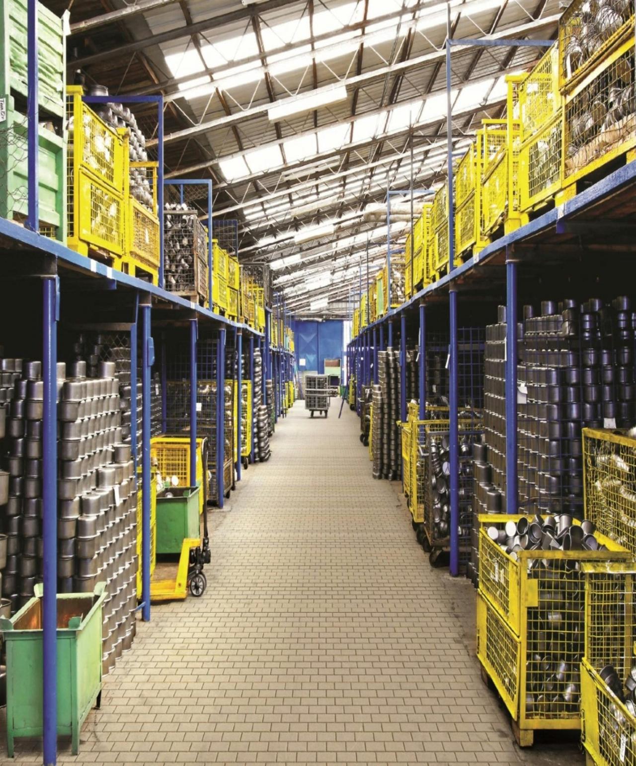 Image of a industrial warehouse corridor with blue and yellow metal shelving