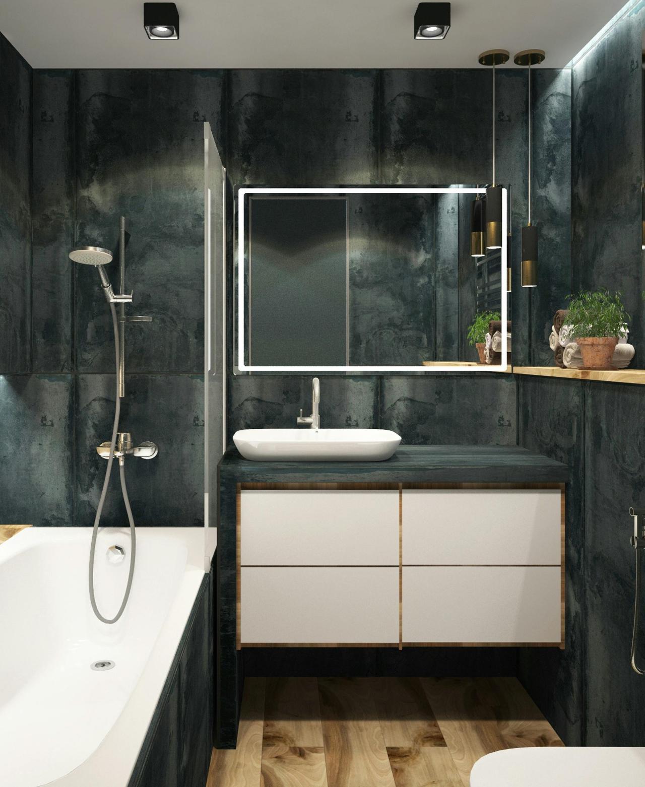 Image of a grey tiled bath with light wooden flooring, showing the sink, bath and the edge of the toilet