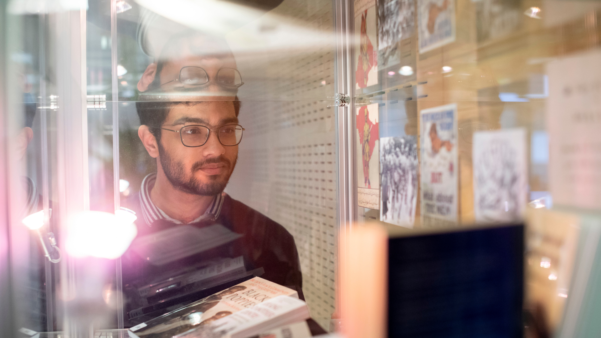 Student looking into Library Display Case