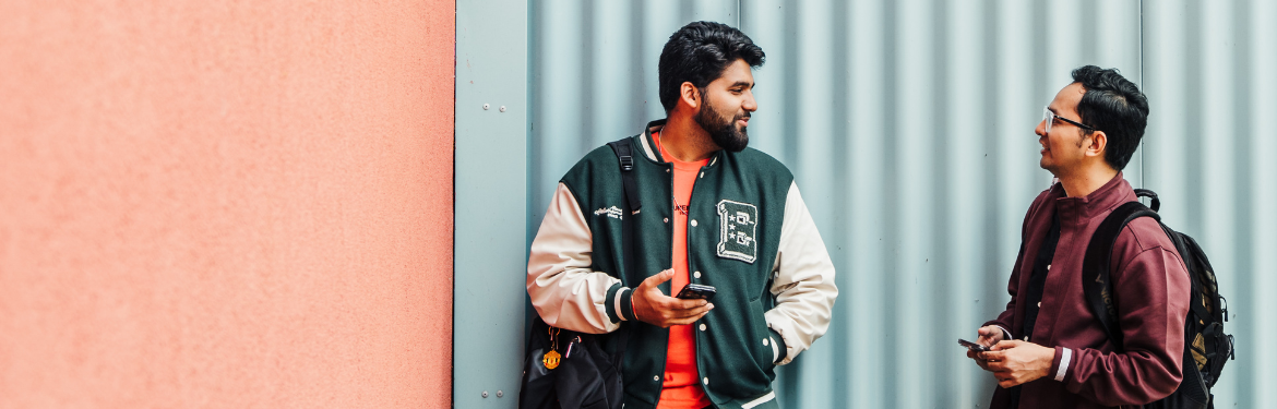 Two students looking at a mobile phone