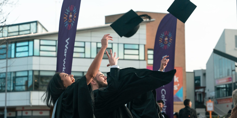 Graduating students throwing caps