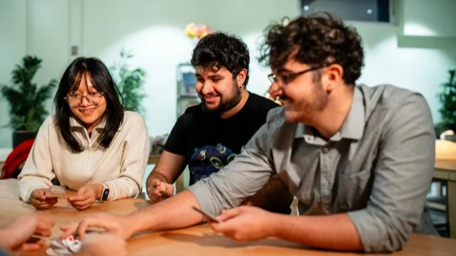 A group of students sitting around a table playing games