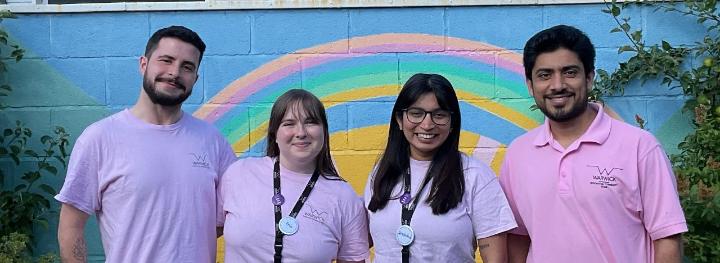 four members of the RCT team stand together smiling in their pink t-shirts