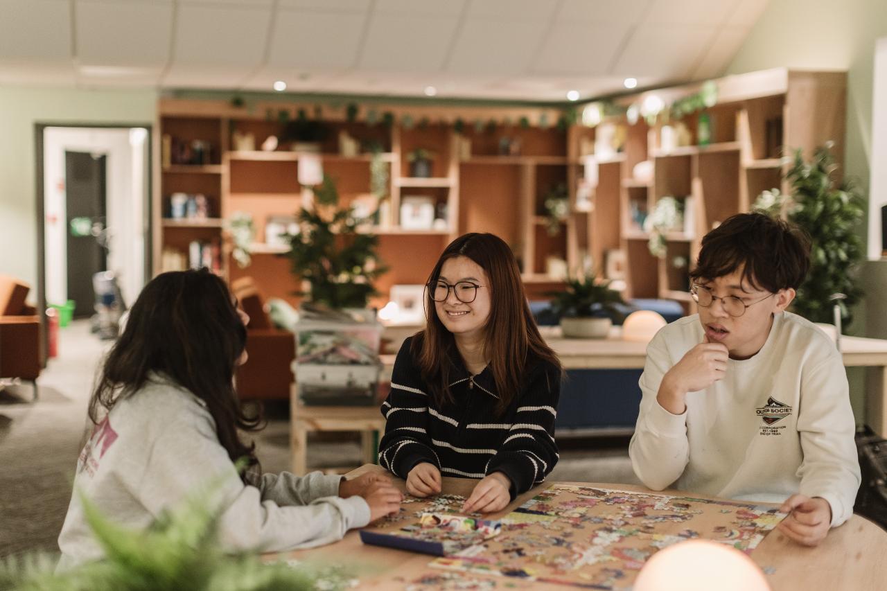 Three Students Playin gBoard Games in The Nook space 