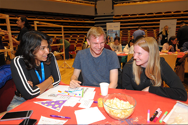 Three students talking at the International Students' Welcome event, September 2023.