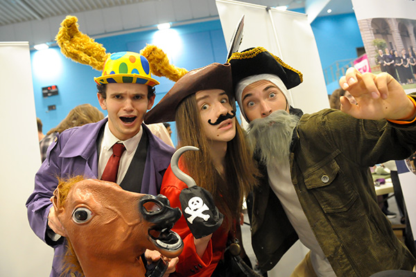Warwick Panto Society members in costume - from left to right, a person in a hat with donkey ears, a person dressed as Captain Hook and a person dresed as a pirate with a beard.