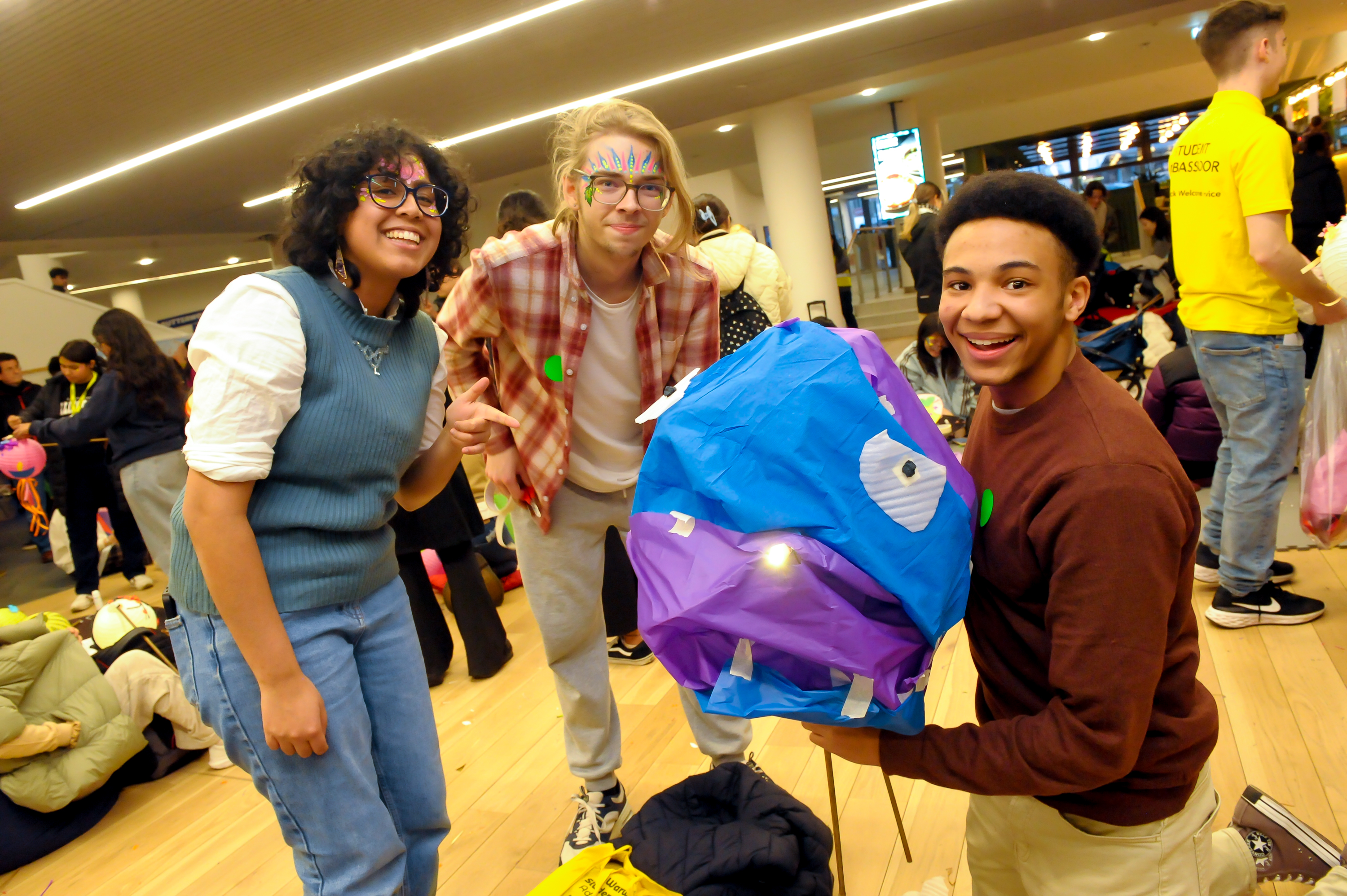 A group of students proudly present their lantern to the camera.