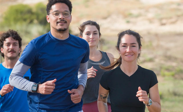 A group of people running together and smiling