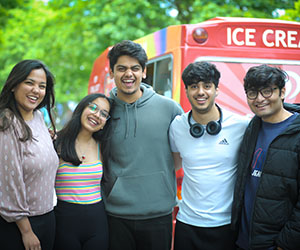 A group of students smile at the camera.