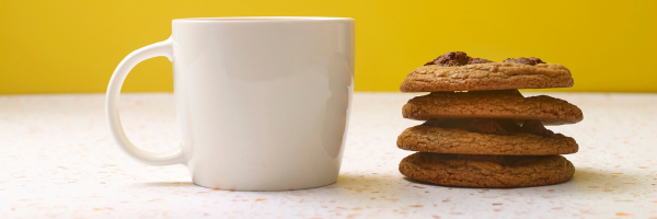 A cup of coffee and stack of biscuits