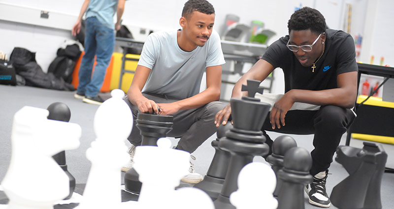 Two students play giant chess